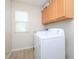 Bright laundry room featuring washer and dryer, tiled floors, and natural light from window at 3515 Mountain Brook Cir, Durham, NC 27704