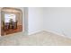 Living space with soft carpeting, and dining room view through an arch at 3515 Mountain Brook Cir, Durham, NC 27704