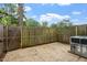 Fenced-in backyard with a small concrete patio and an air conditioning unit at 3720 Jamestown Cir, Raleigh, NC 27609