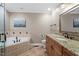 Spacious bathroom featuring a jetted tub, granite vanity, and tile flooring at 3720 Jamestown Cir, Raleigh, NC 27609