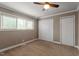 This bedroom has neutral walls, carpet flooring, a window, and two closets at 3720 Jamestown Cir, Raleigh, NC 27609