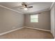 Neutral bedroom featuring carpet flooring, a ceiling fan, and a window with natural light at 3720 Jamestown Cir, Raleigh, NC 27609