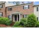 Charming brick home with a covered entrance, black shutters, and landscaped front yard at 3720 Jamestown Cir, Raleigh, NC 27609