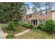 Charming brick home with a covered entrance, black shutters, and landscaped front yard at 3720 Jamestown Cir, Raleigh, NC 27609