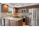 Bright kitchen with stainless appliances, granite counters, custom cabinetry, and hardwood floors at 3720 Jamestown Cir, Raleigh, NC 27609