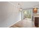 View of the kitchen and dining area, including a sliding glass door to the backyard at 3720 Jamestown Cir, Raleigh, NC 27609