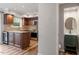 Modern kitchen with stainless appliances, granite countertops, island, and view of half bath at 3720 Jamestown Cir, Raleigh, NC 27609