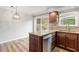 Well-appointed kitchen with stainless steel dishwasher, granite counters, and outdoor access at 3720 Jamestown Cir, Raleigh, NC 27609