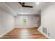 Bright living room features new wood floors, modern ceiling fan, and freshly painted walls at 3720 Jamestown Cir, Raleigh, NC 27609