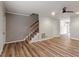 The living room offers a modern ceiling fan, staircase, and hardwood floors at 3720 Jamestown Cir, Raleigh, NC 27609