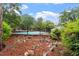 View of a community pool surrounded by lush greenery and a black metal fence at 3720 Jamestown Cir, Raleigh, NC 27609
