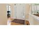 Bright foyer featuring wood floors, a white front door with sidelights and transom, and a decorative area rug at 3928 Bentley Bridge Rd, Raleigh, NC 27612