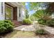 Beautiful front entrance featuring brick steps, mature landscaping, and a welcoming walkway at 3928 Bentley Bridge Rd, Raleigh, NC 27612