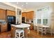 Bright kitchen featuring wooden cabinetry, modern appliances, and a dining area with natural light at 3928 Bentley Bridge Rd, Raleigh, NC 27612