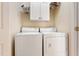 Functional laundry room with washer, dryer, and overhead storage at 3928 Bentley Bridge Rd, Raleigh, NC 27612