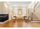 Cozy living room featuring hardwood floors, a fireplace, comfortable seating, and a staircase leading to the upper level at 3928 Bentley Bridge Rd, Raleigh, NC 27612