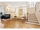 Inviting living room featuring hardwood floors, a fireplace, comfortable seating, and a staircase to the upper level at 3928 Bentley Bridge Rd, Raleigh, NC 27612