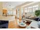 Bright living room featuring hardwood floors, a large bay window, and an open layout to the kitchen at 3928 Bentley Bridge Rd, Raleigh, NC 27612