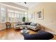 Sunny living room with a large bay window, hardwood floors, and stylish furnishings at 3928 Bentley Bridge Rd, Raleigh, NC 27612