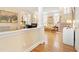 Elegant living room featuring hardwood floors, a staircase and a glimpse of the fireplace, and lots of natural light at 3928 Bentley Bridge Rd, Raleigh, NC 27612