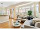 Bright and spacious living room featuring hardwood floors, a comfortable sofa, and a large bay window at 3928 Bentley Bridge Rd, Raleigh, NC 27612