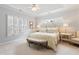 Serene main bedroom with a tray ceiling, ample natural light, and a cozy sitting area at 3928 Bentley Bridge Rd, Raleigh, NC 27612