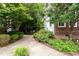 Lush landscaping frames the paved walkway leading to this lovely residence at 3928 Bentley Bridge Rd, Raleigh, NC 27612