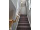 Carpeted staircase features wooden handrail and leads to the upper level with ample natural light at 4202 Cherry Blossom Cir, Durham, NC 27713