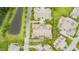 Bird's eye view of neighborhood with neatly arranged condos, green spaces, and a serene pond at 425 Faith Dr, Gibsonville, NC 27249