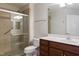 Bathroom featuring a walk-in shower, large mirror and wood vanity at 425 Faith Dr, Gibsonville, NC 27249