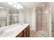 Bright bathroom with a double vanity, large mirror, walk-in shower, and linen closet at 425 Faith Dr, Gibsonville, NC 27249