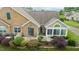 Aerial view of a well-kept condo with stone facade, green shutters, and a landscaped yard at 425 Faith Dr, Gibsonville, NC 27249