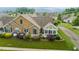 Aerial view of stone-clad condo with lush landscaping, green shutters and manicured lawn at 425 Faith Dr, Gibsonville, NC 27249