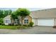 Charming home featuring a stone facade, attached garage, manicured landscaping, and a well-maintained lawn at 425 Faith Dr, Gibsonville, NC 27249