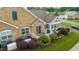 Aerial shot of condo featuring stone facade, pristine lawn, and a Generac generator system at 425 Faith Dr, Gibsonville, NC 27249