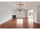 Bright living room boasts a fireplace, hardwood floors, and arched window at 425 Faith Dr, Gibsonville, NC 27249