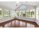 Sunroom boasts hardwood floors and is surrounded by windows with exterior views at 425 Faith Dr, Gibsonville, NC 27249