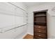 Spacious walk-in closet featuring custom shelving and a wooden cabinet to maximize storage at 425 Faith Dr, Gibsonville, NC 27249