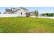 Spacious backyard with lush green grass and a white fence at 44 Good Morning Ln, Garner, NC 27529