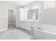 Bathroom with dual sink vanity, soaking tub and private water closet at 44 Good Morning Ln, Garner, NC 27529