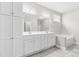 Bathroom featuring a double vanity, soaking tub, and large linen storage cabinet at 44 Good Morning Ln, Garner, NC 27529