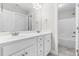 A modern bathroom featuring double sinks, white cabinets, and a shower-tub combo at 44 Good Morning Ln, Garner, NC 27529
