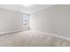 Bright, neutral bedroom with plush carpet and natural light from a window at 44 Good Morning Ln, Garner, NC 27529