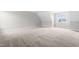 A spacious bonus room featuring neutral carpet and natural light from a window at 44 Good Morning Ln, Garner, NC 27529