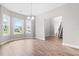 Bright dining area with hardwood floors and large windows offering scenic outdoor views at 44 Good Morning Ln, Garner, NC 27529