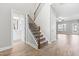 Inviting entryway featuring a staircase, hardwood floors, and access to a powder room at 44 Good Morning Ln, Garner, NC 27529