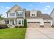 Charming two-story home showcasing a three-car garage and a lush green lawn at 44 Good Morning Ln, Garner, NC 27529