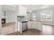 Modern kitchen featuring white cabinets, stainless steel appliances, and granite countertops at 44 Good Morning Ln, Garner, NC 27529