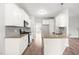 Well-lit kitchen with white cabinetry, stainless steel appliances, and wood-look flooring at 44 Good Morning Ln, Garner, NC 27529