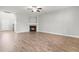 Spacious living room with fireplace, ceiling fan, and beautiful wood-look flooring at 44 Good Morning Ln, Garner, NC 27529